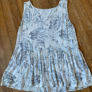 White/navy floral print loose-fit peplum tank.